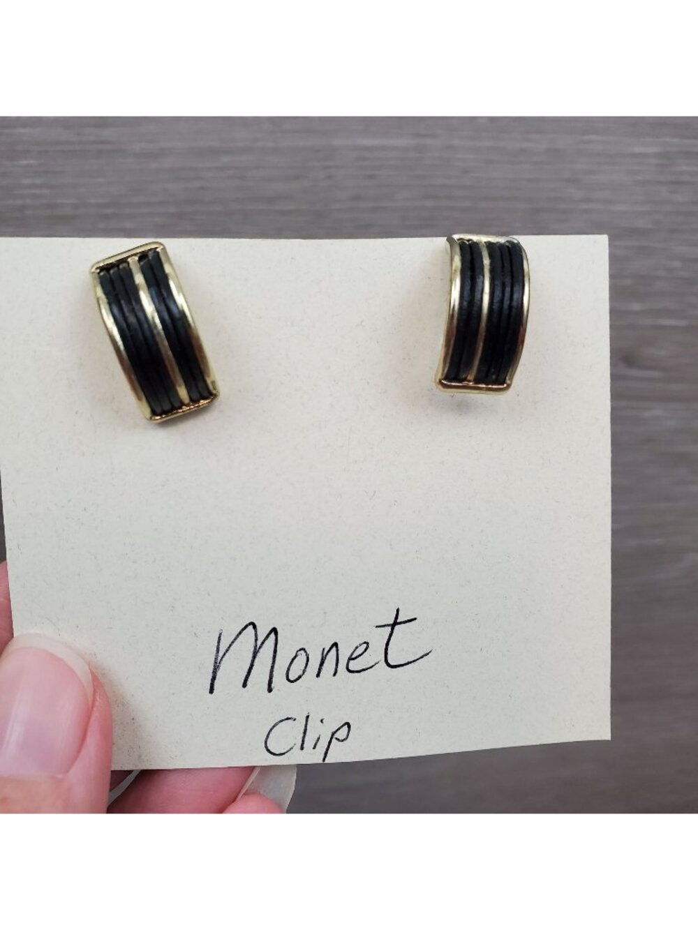 Monet black and gold-tone curved clip on earrings